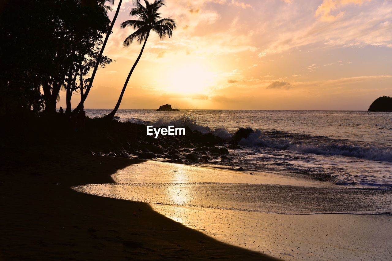 Scenic view of beach against sky during sunset