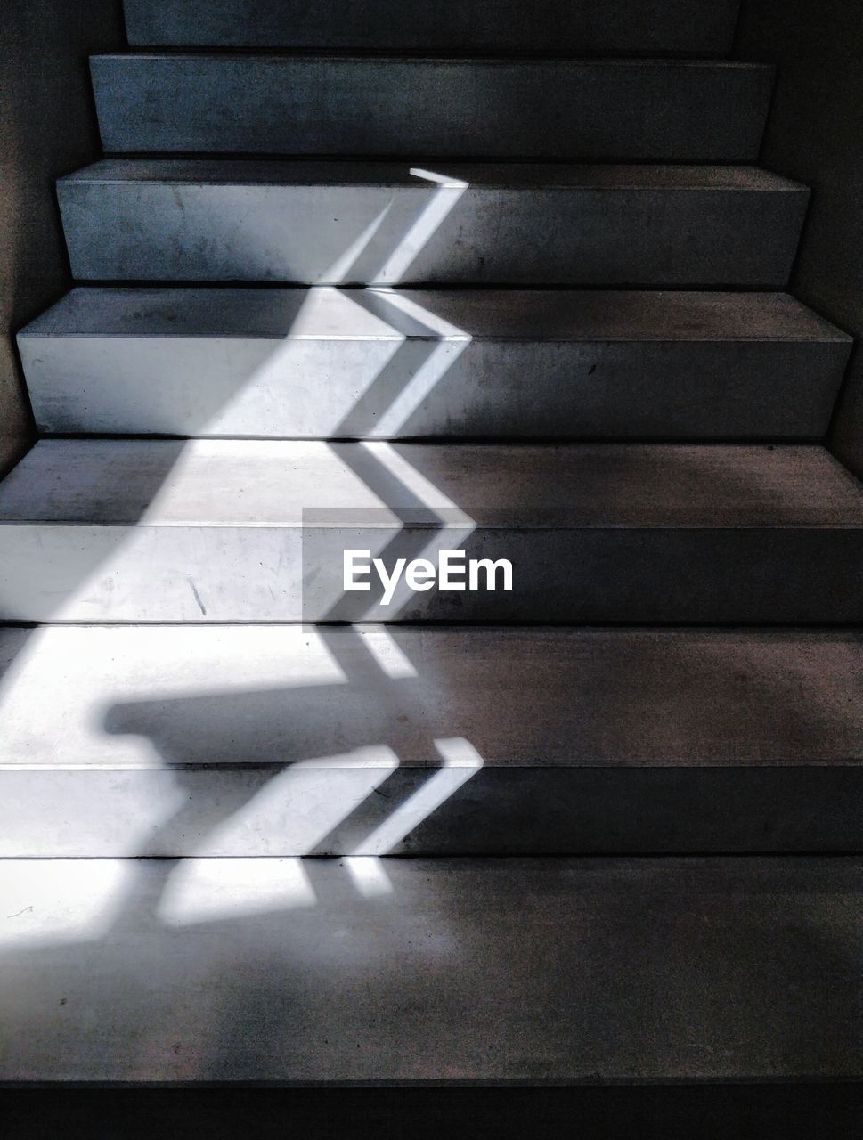 High angle view of light and shadow on concrete staircase