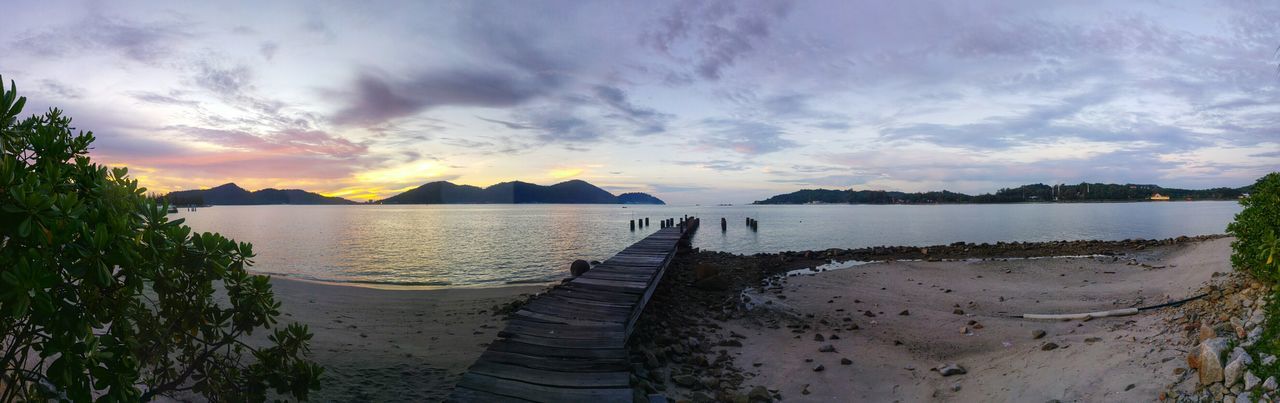 Panoramic view of pier at lake against sky during sunset