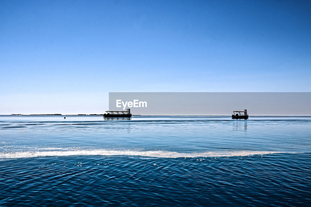 SHIP IN SEA AGAINST CLEAR BLUE SKY