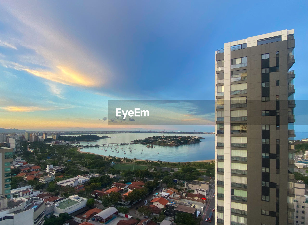 architecture, city, building exterior, built structure, building, sky, tower block, cityscape, residential district, nature, residential area, skyline, water, skyscraper, urban area, metropolitan area, horizon, cloud, sea, high angle view, office building exterior, landscape, no people, tower, condominium, metropolis, urban skyline, apartment, downtown, outdoors, travel destinations, sunset, environment, house, city life, neighbourhood, travel, blue, transportation, business finance and industry, beach, street