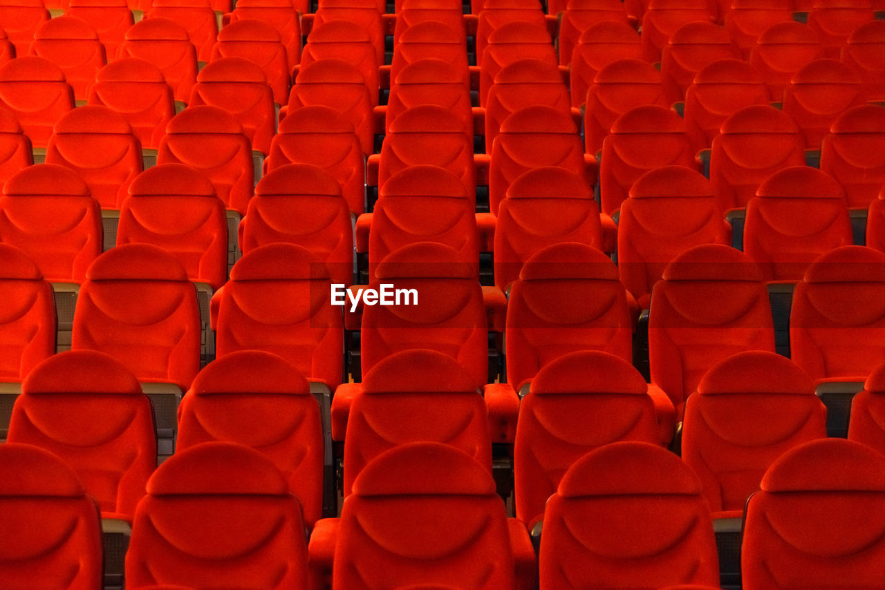 full frame shot of red chairs in theater
