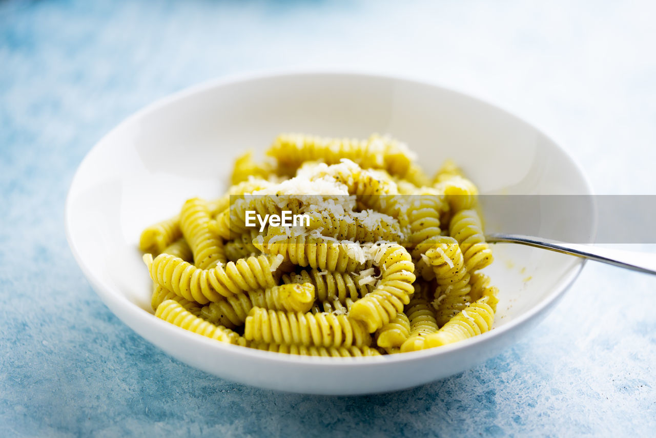 Plate of pasta with pesto genovese, with fresh basil, olive oil, garlic and pine nuts
