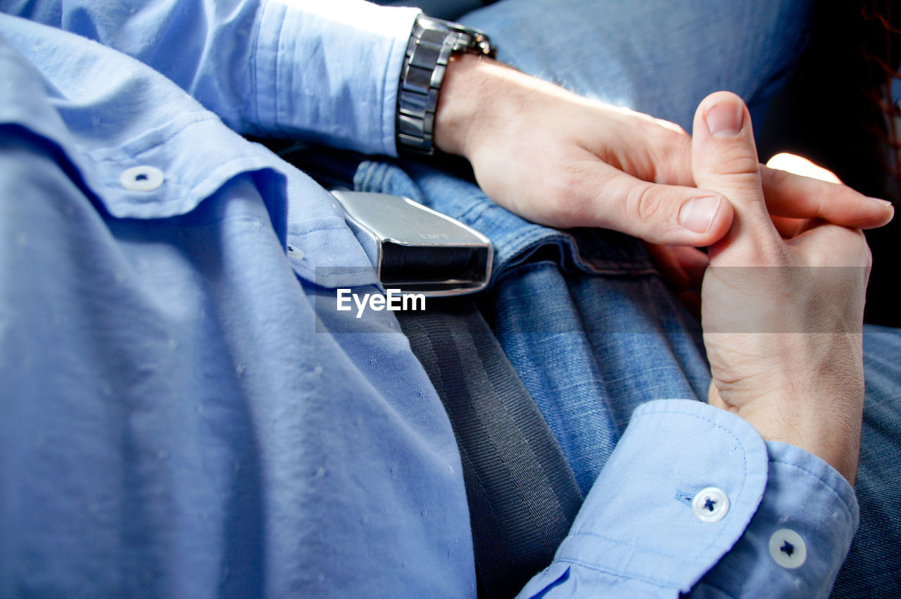 Midsection of man traveling in airplane