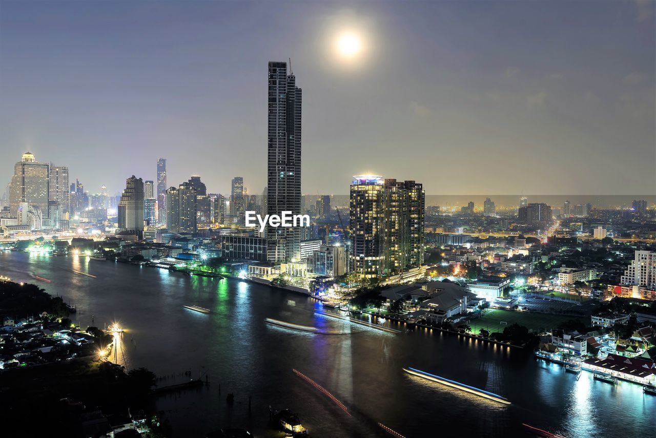 ILLUMINATED BUILDINGS IN CITY AT NIGHT