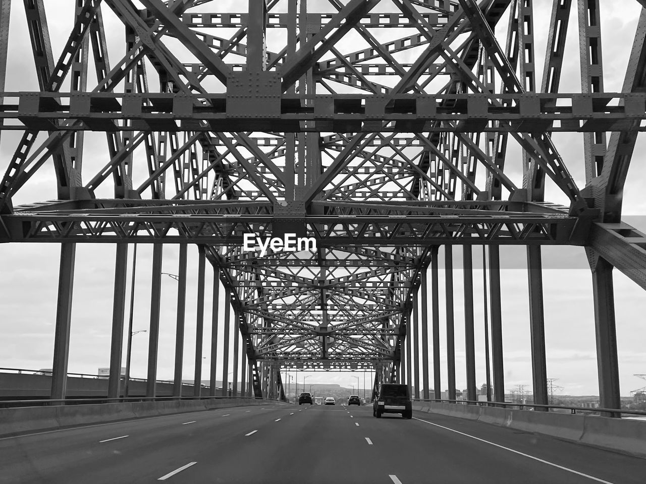 transportation, architecture, built structure, bridge, black and white, road, monochrome, monochrome photography, engineering, city, car, overpass, metal, motor vehicle, mode of transportation, nature, travel destinations, cantilever bridge, symbol, day, line, travel, sign, the way forward, outdoors, sky, infrastructure, lane, land vehicle, highway, diminishing perspective, water, street, alloy