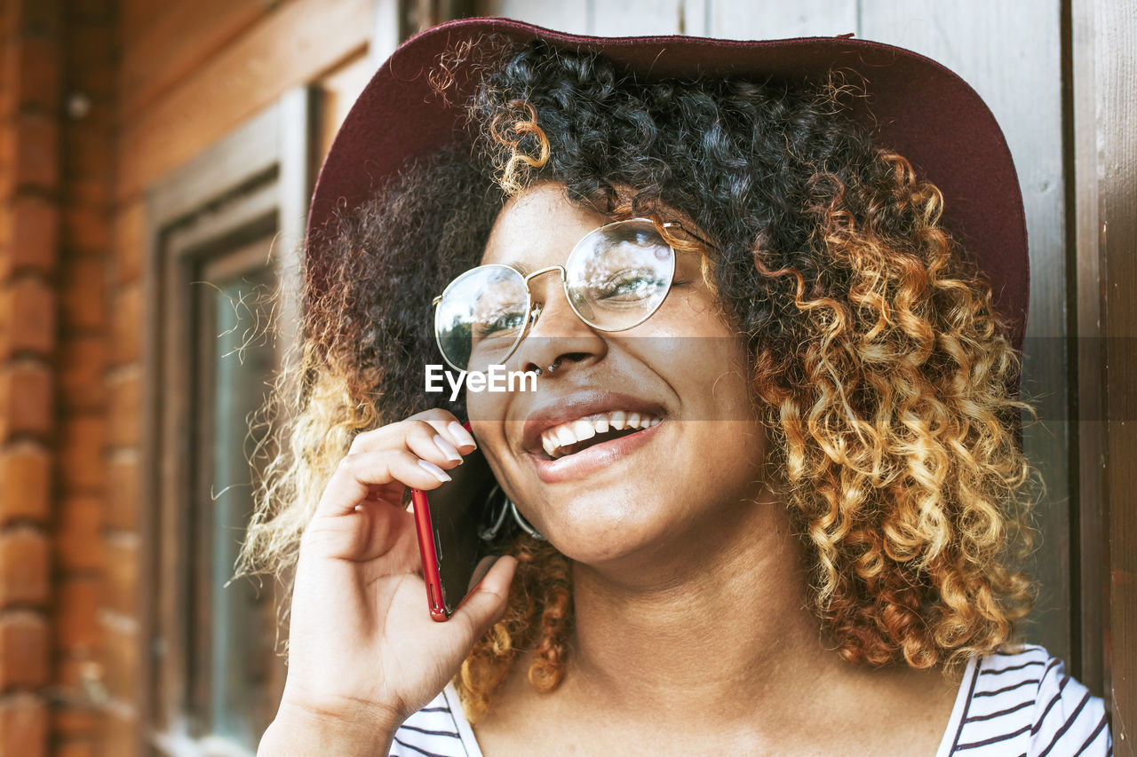 Young woman talking on mobile phone fashion