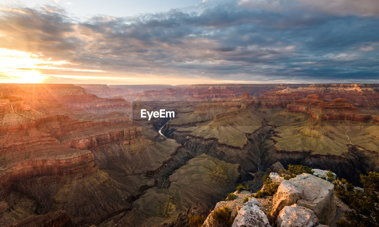 Scenic view of dramatic landscape against sky during sunset