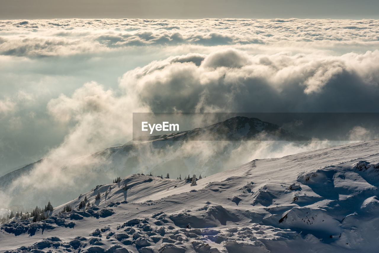 Scenic view of snow covered mountains against sky