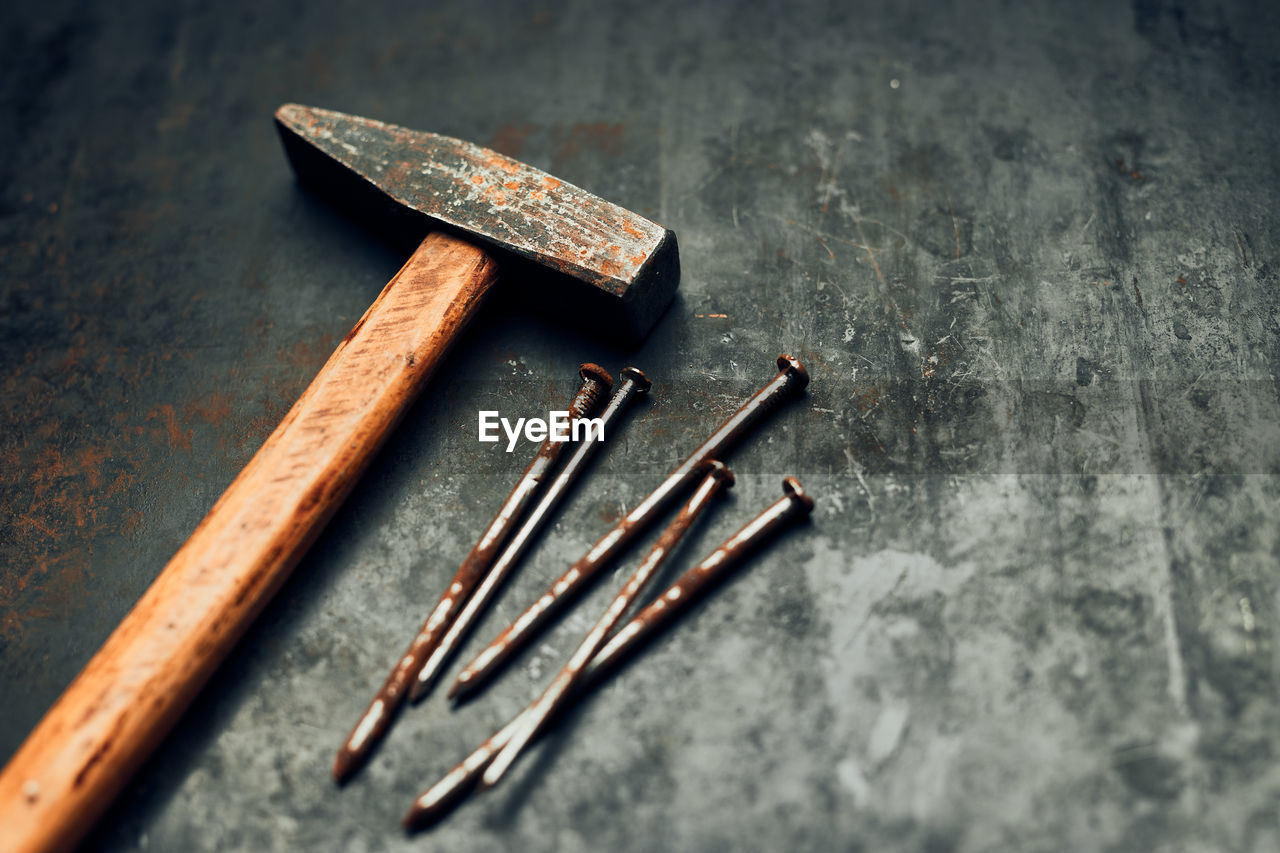 Hammer and nails on steel surface. tools for maintenance. hardware tools to fix. tech background