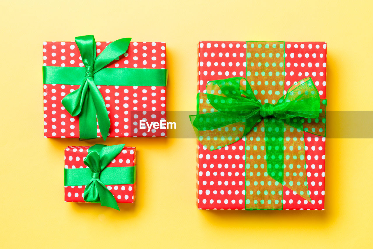 Holiday handmade present in paper on colorful background. present box on colored table, top view.