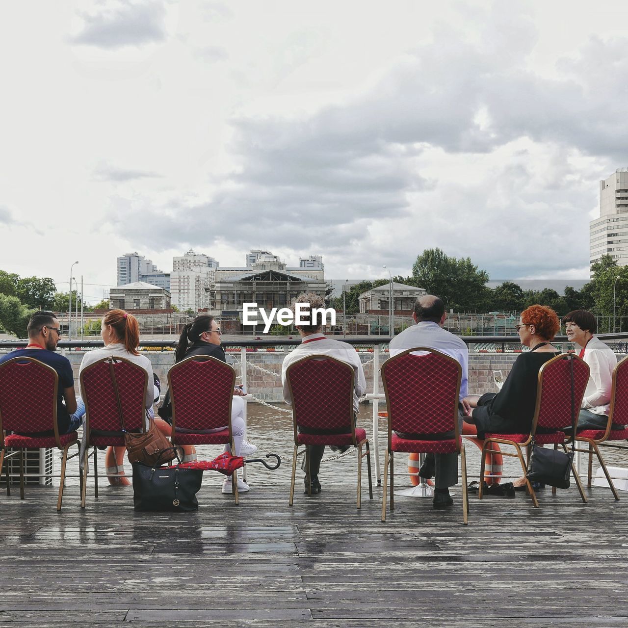 PEOPLE SITTING ON TABLE IN CITY