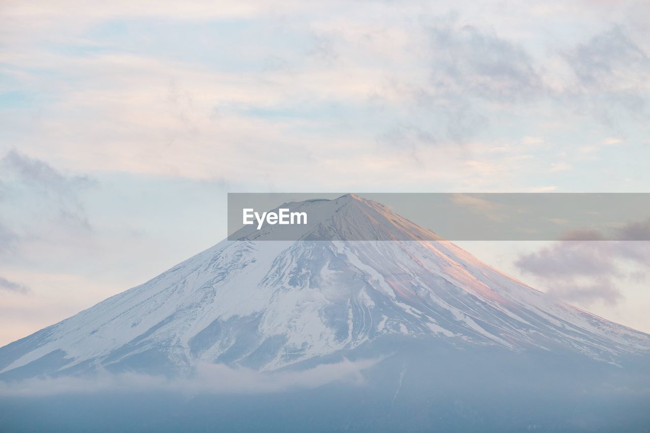 Snowcapped mountain against sky during winter