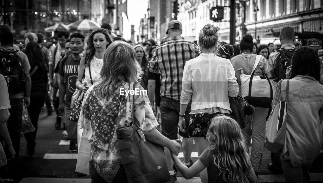 PEOPLE ON CITY STREET