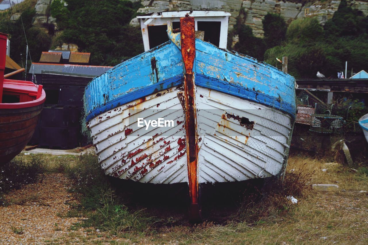 Old boats moored on field