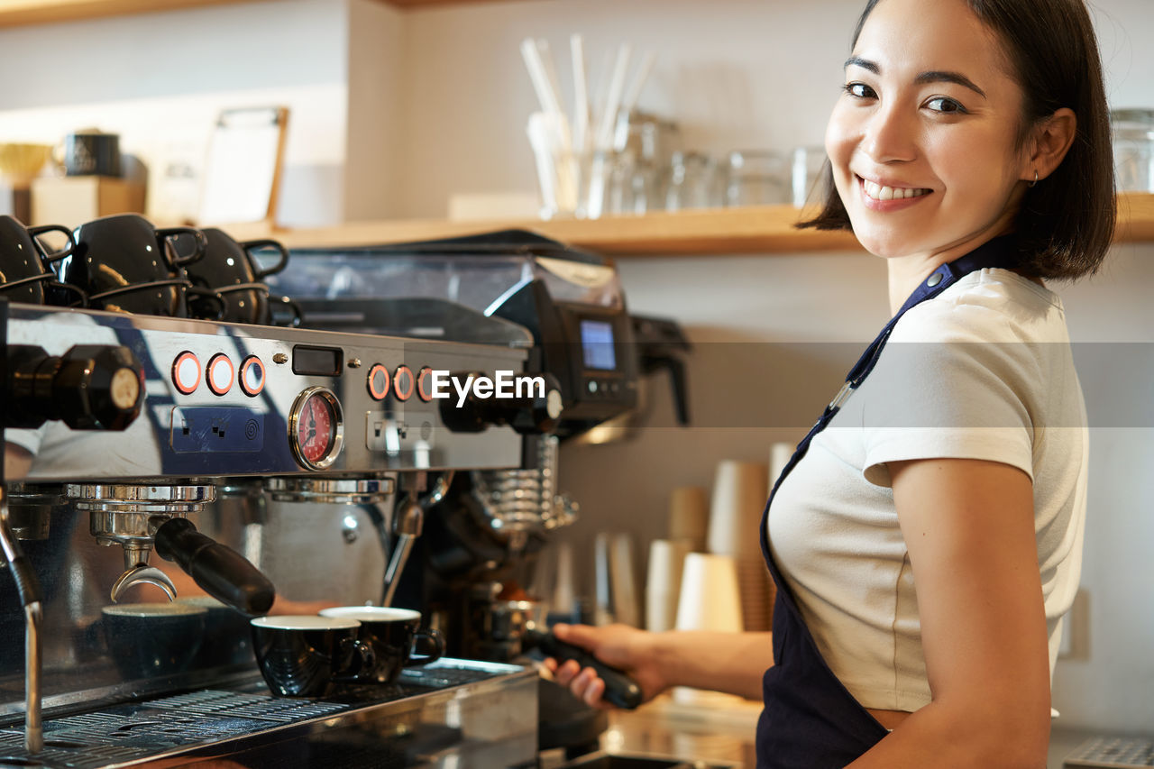 side view of young woman holding coffee