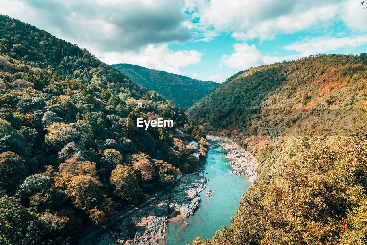 High angle view of river amidst mountains against sky