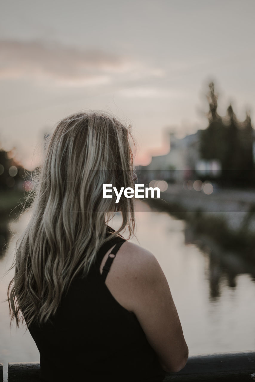 Woman looking away during sunset