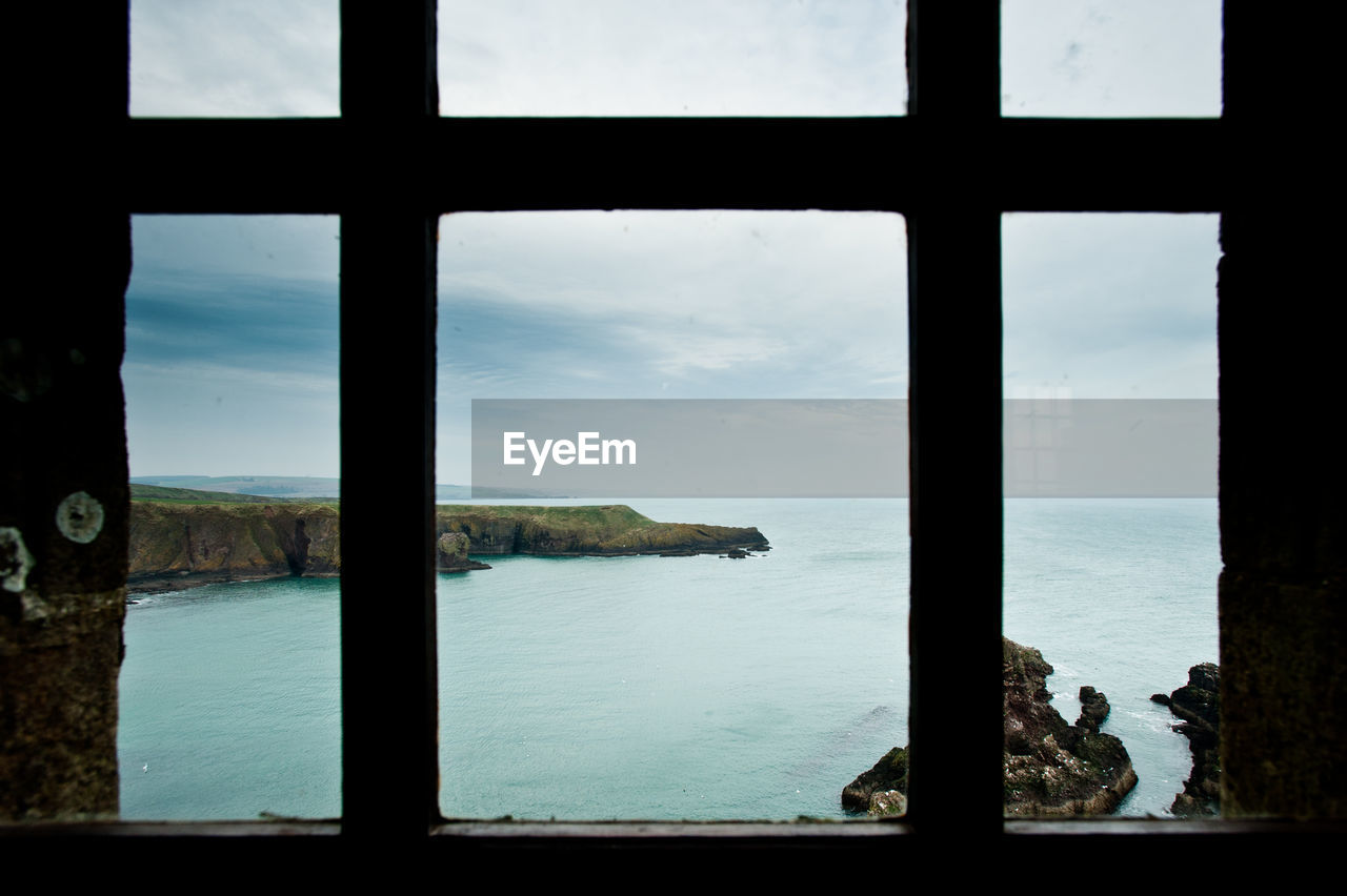 SEA SEEN THROUGH GLASS WINDOW