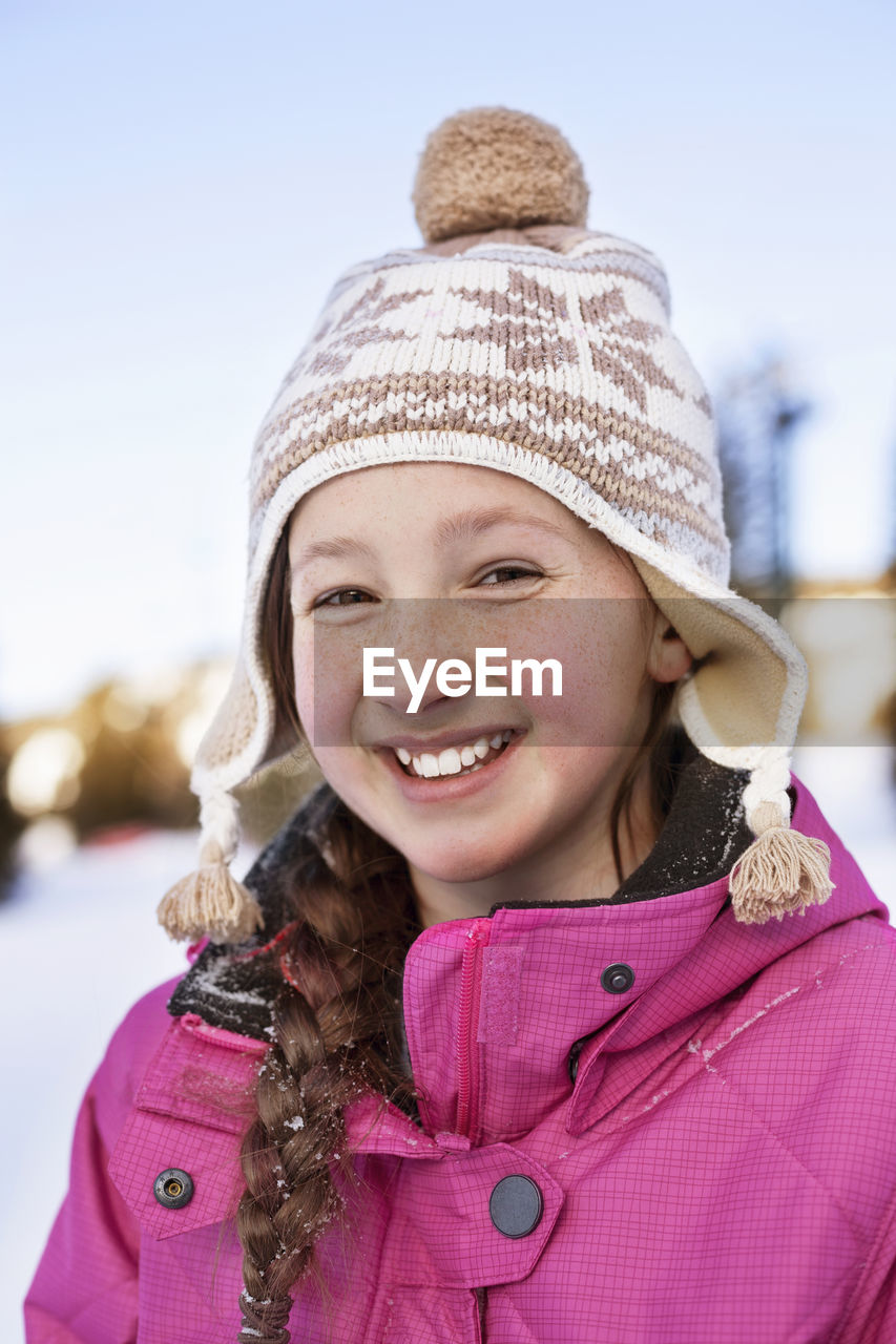 Portrait of happy girl in warm clothing