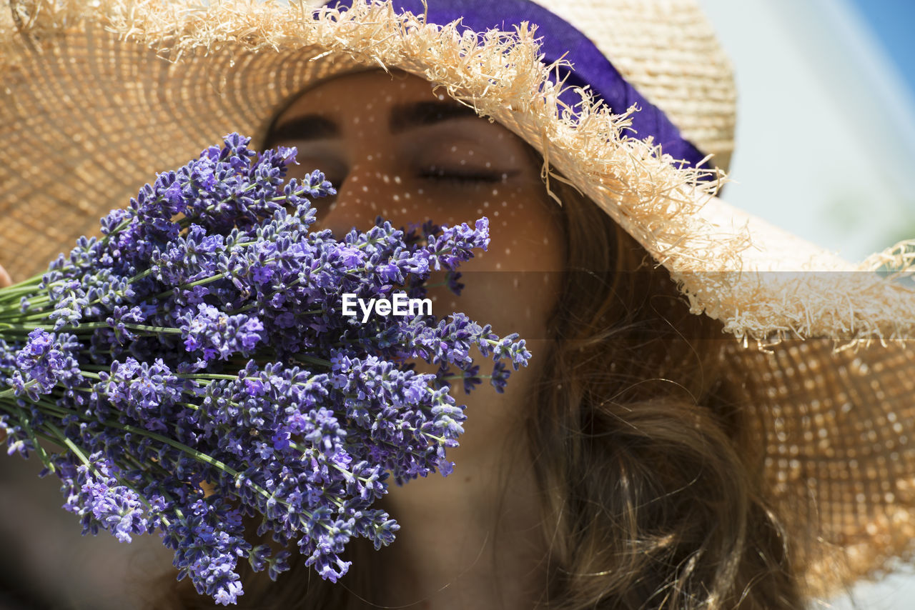 Close up photo of a woman and a lavender bouquet