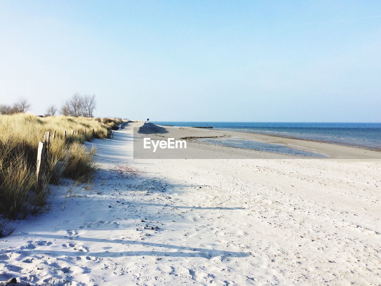 Scenic view of beach against clear sky