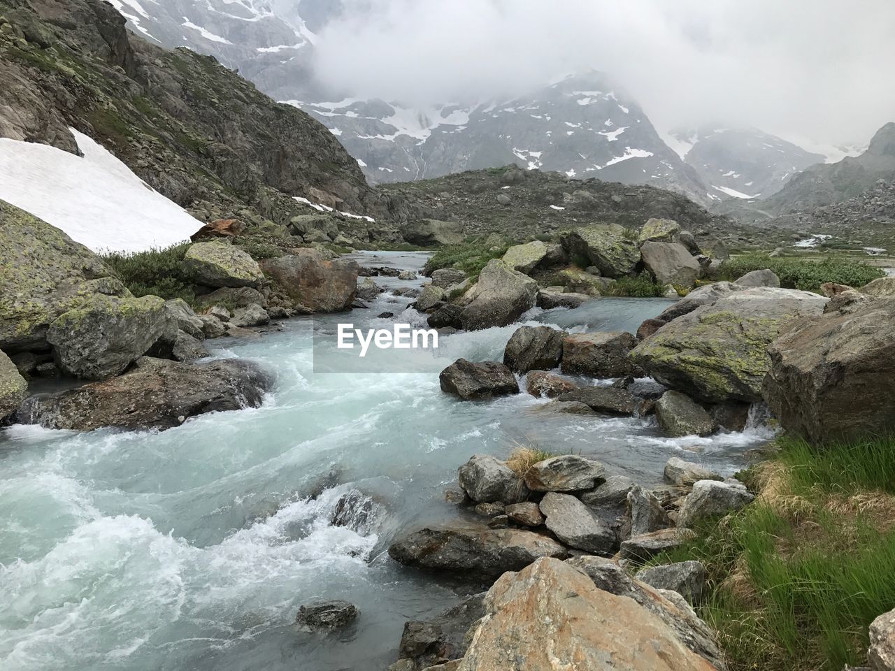 Scenic view of river and mountains against sky