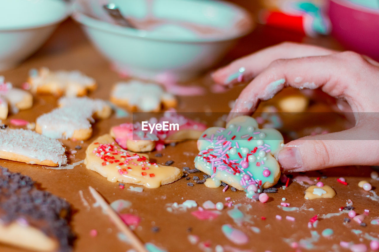 Cropped image of woman making cookie on table
