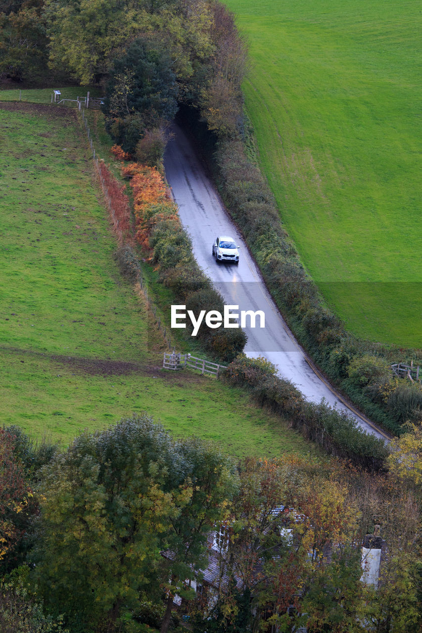 HIGH ANGLE VIEW OF ROAD AMIDST LAND