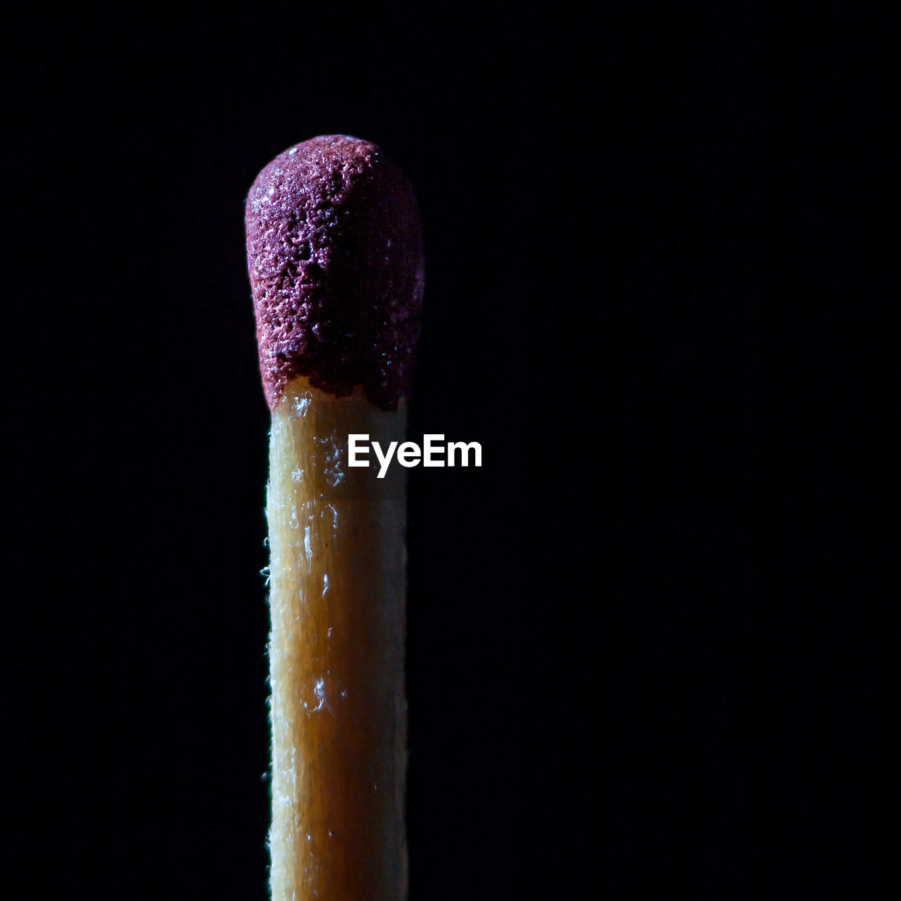 Close-up of matchstick over black background