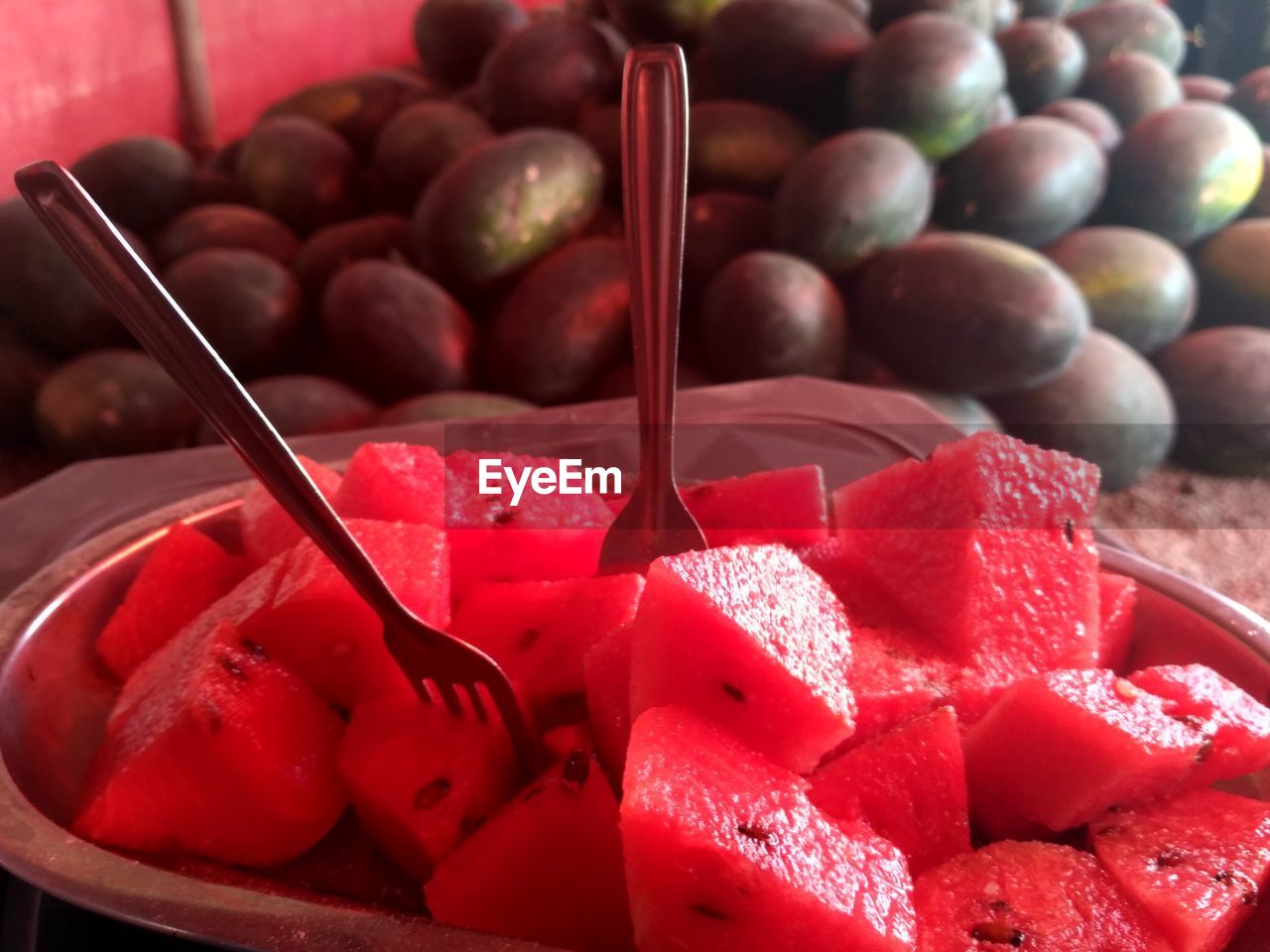 Close-up of watermelon slices in plate at market stall