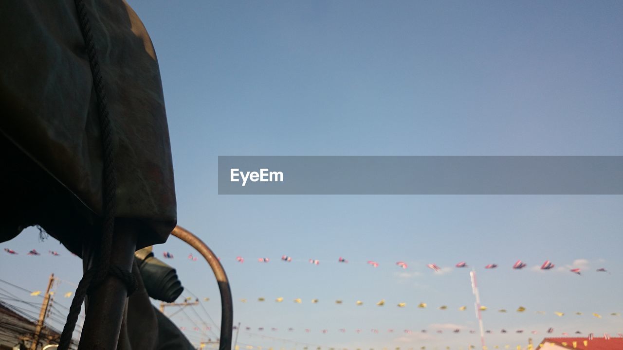 LOW ANGLE VIEW OF FLAGS AGAINST CLEAR SKY