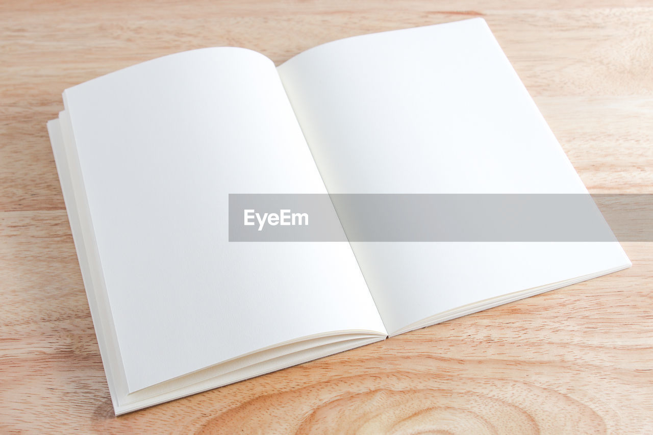 copy space, indoors, paper, table, publication, book, no people, wood, page, white, high angle view, rectangle, note pad, simplicity, document, studio shot, still life, directly above, diary, close-up, education, empty, single object, open