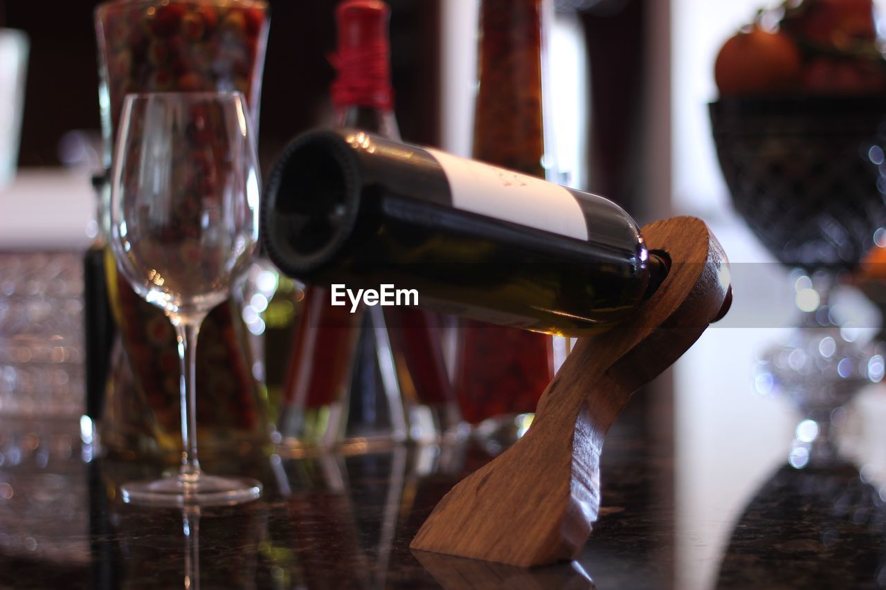 Close-up of wineglass and bottle on table