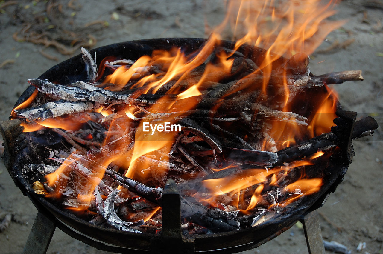 Close-up of fire pit on field at night