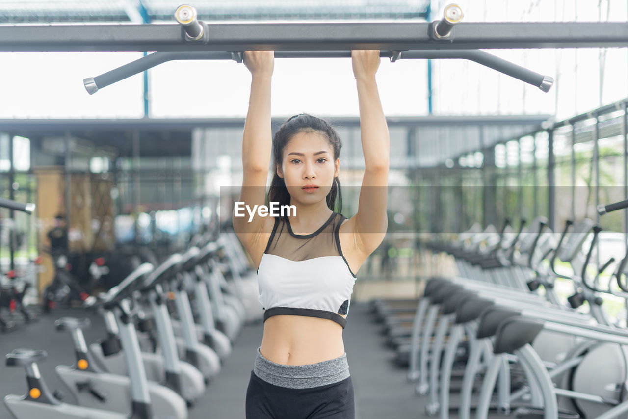 Portrait of confident woman exercising at gym