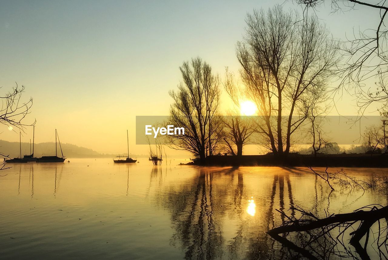 Scenic view of lake against sky during sunset