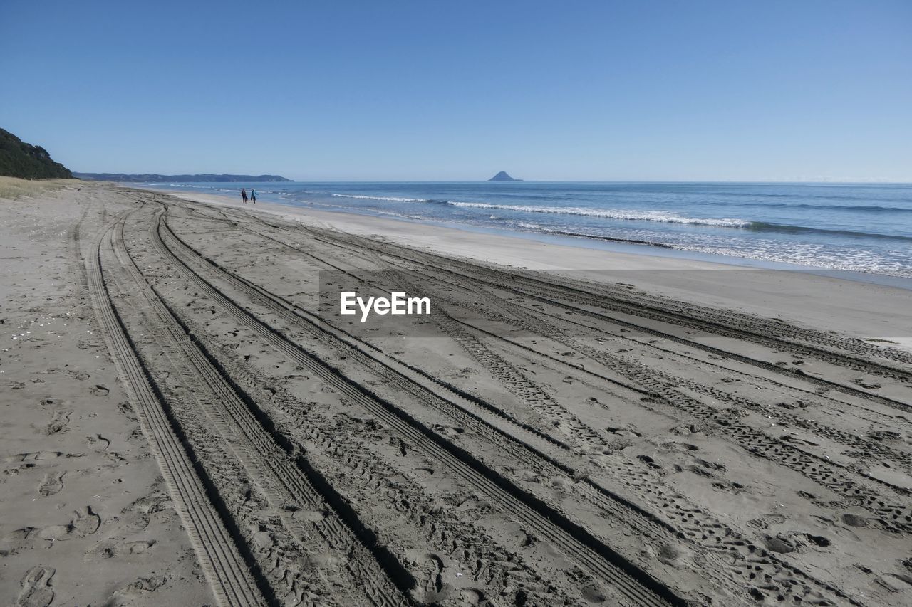 SCENIC VIEW OF BEACH BY SEA AGAINST CLEAR SKY