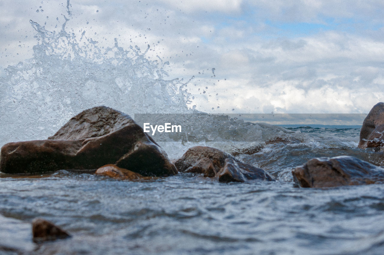 Water splashing on rocks in sea