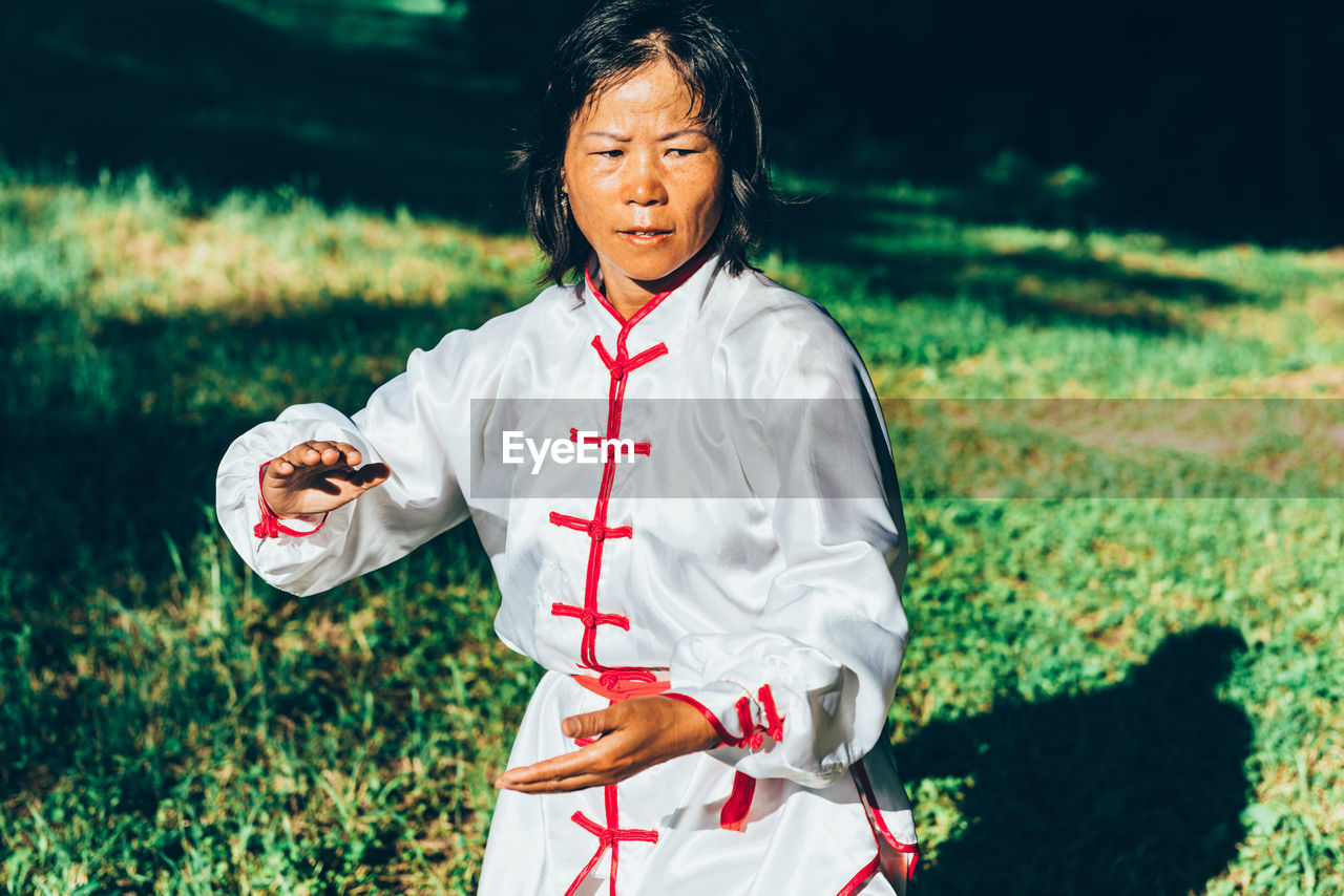 Mature woman practicing martial arts at park