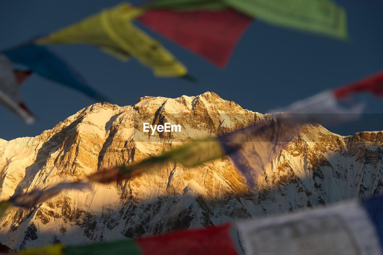 Close-up of tibetan flag on mountain