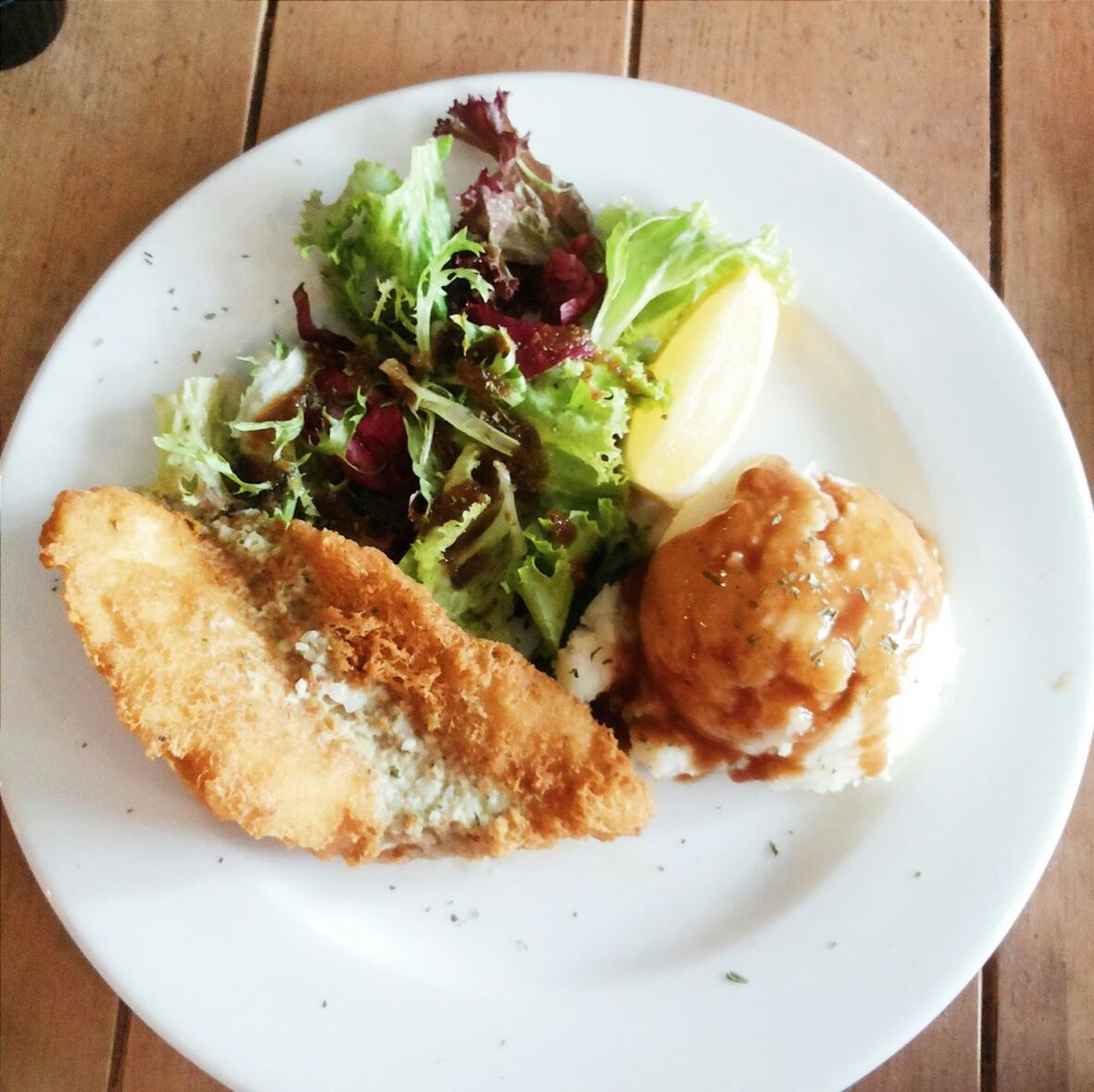 Cooked fish served with salad