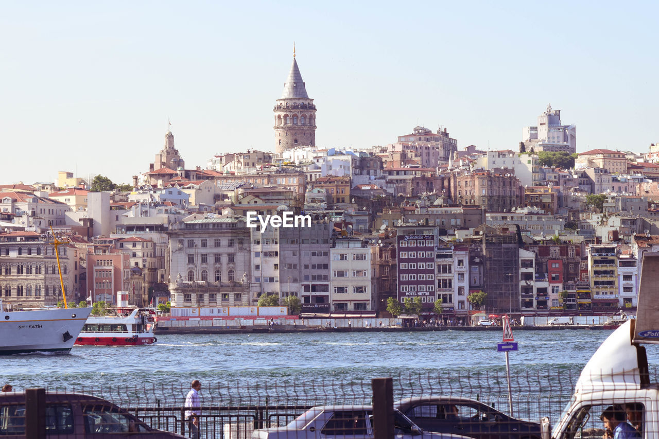 VIEW OF BUILDINGS AGAINST SKY WITH WATERFRONT