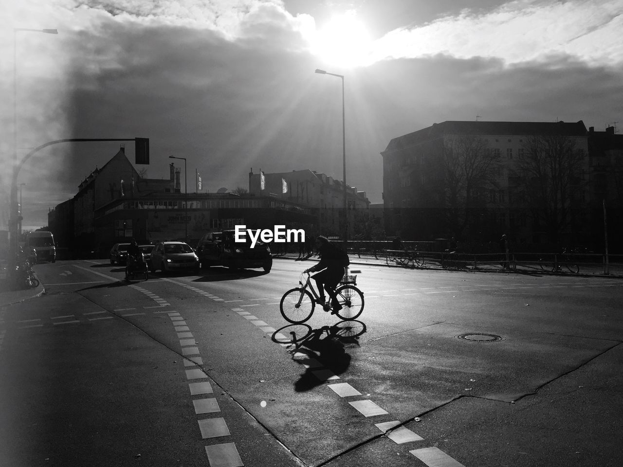 MAN RIDING BICYCLE ON ROAD