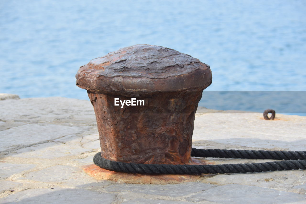 Rope tied to bollard on pier