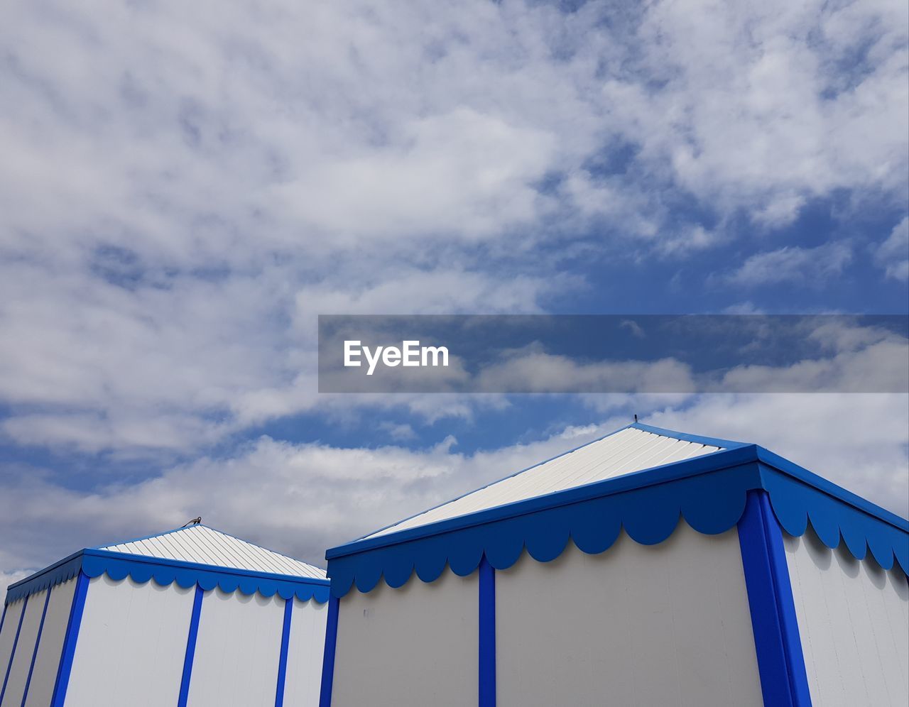 LOW ANGLE VIEW OF BEACH HUTS AGAINST SKY