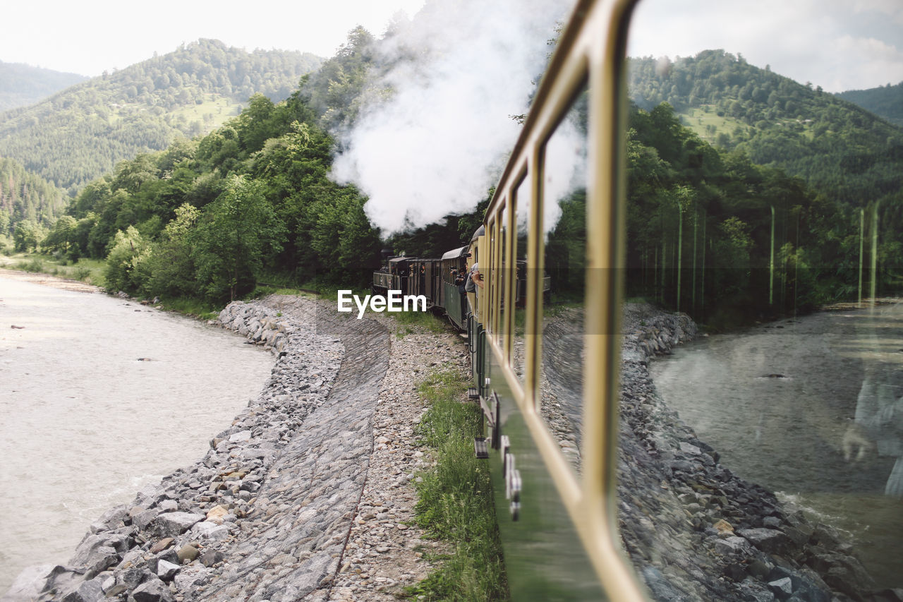 Old-fashioned locomotive train emitting smoke