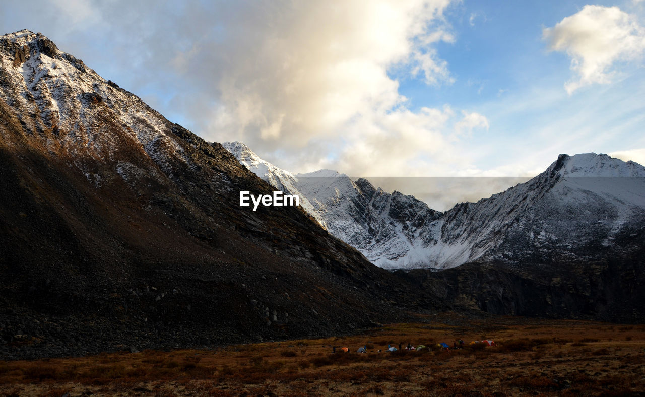 Scenic view of mountains against cloudy sky