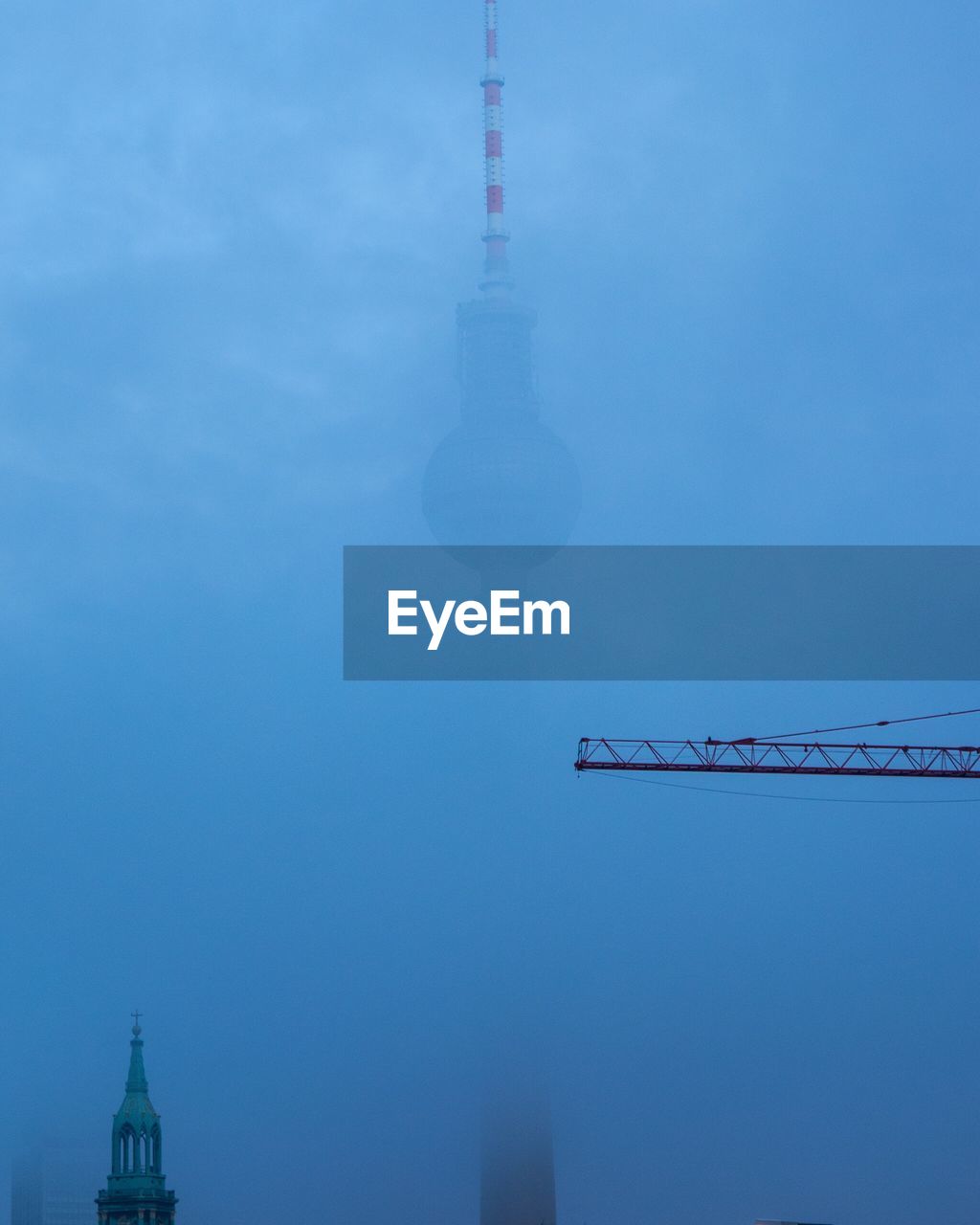 Fernsehturm against sky during foggy weather