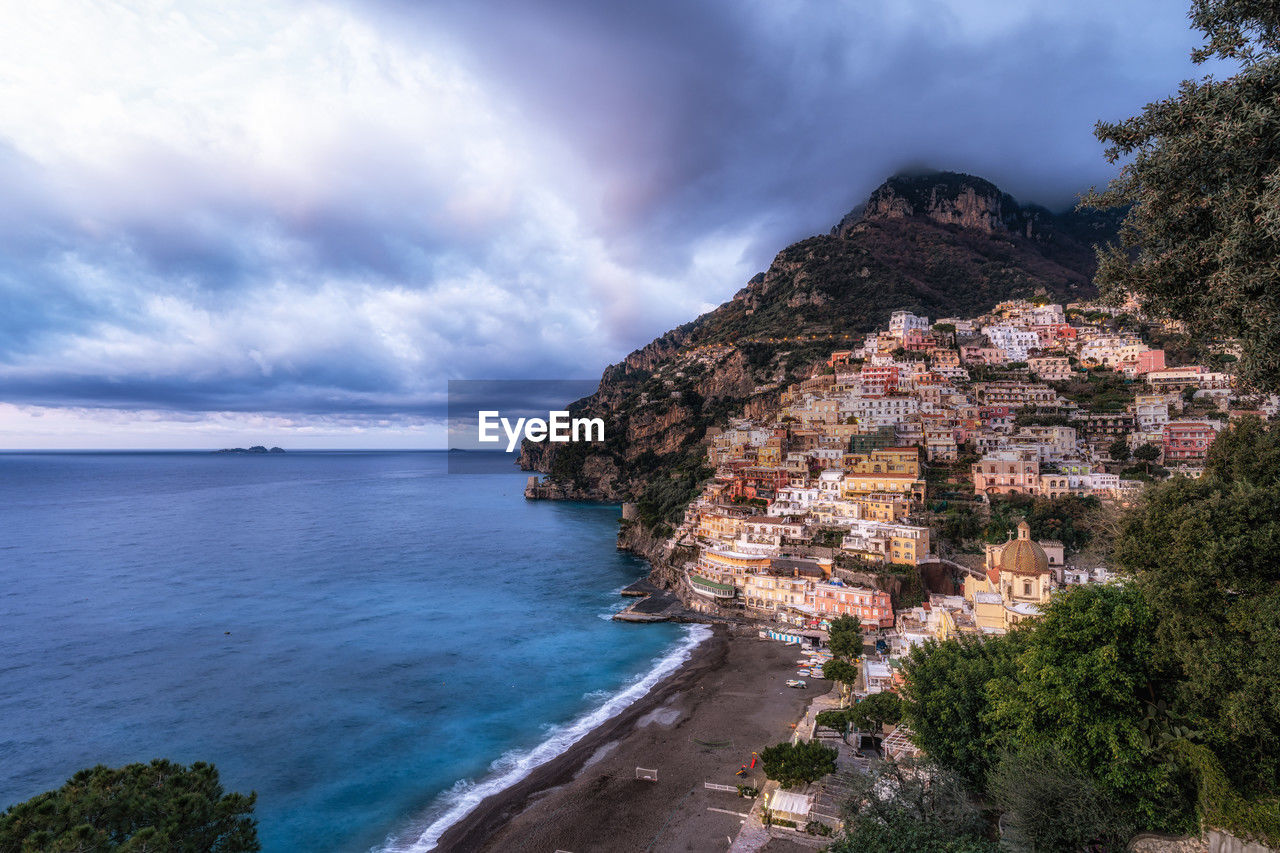 water, sea, land, sky, coast, beach, cloud, scenics - nature, nature, beauty in nature, architecture, travel destinations, cliff, tree, coastline, travel, plant, building exterior, environment, mountain, building, tourism, body of water, landscape, vacation, ocean, built structure, city, no people, outdoors, shore, terrain, rock, tranquility, bay, holiday, trip, day, seascape, tranquil scene, house, island, blue, high angle view, idyllic, horizon over water